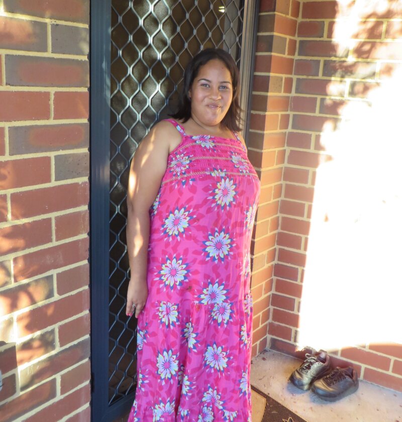 Woman standing next to her front door 